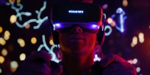 Gamer wearing Oculus Rift, holding controllers, focused on screen.